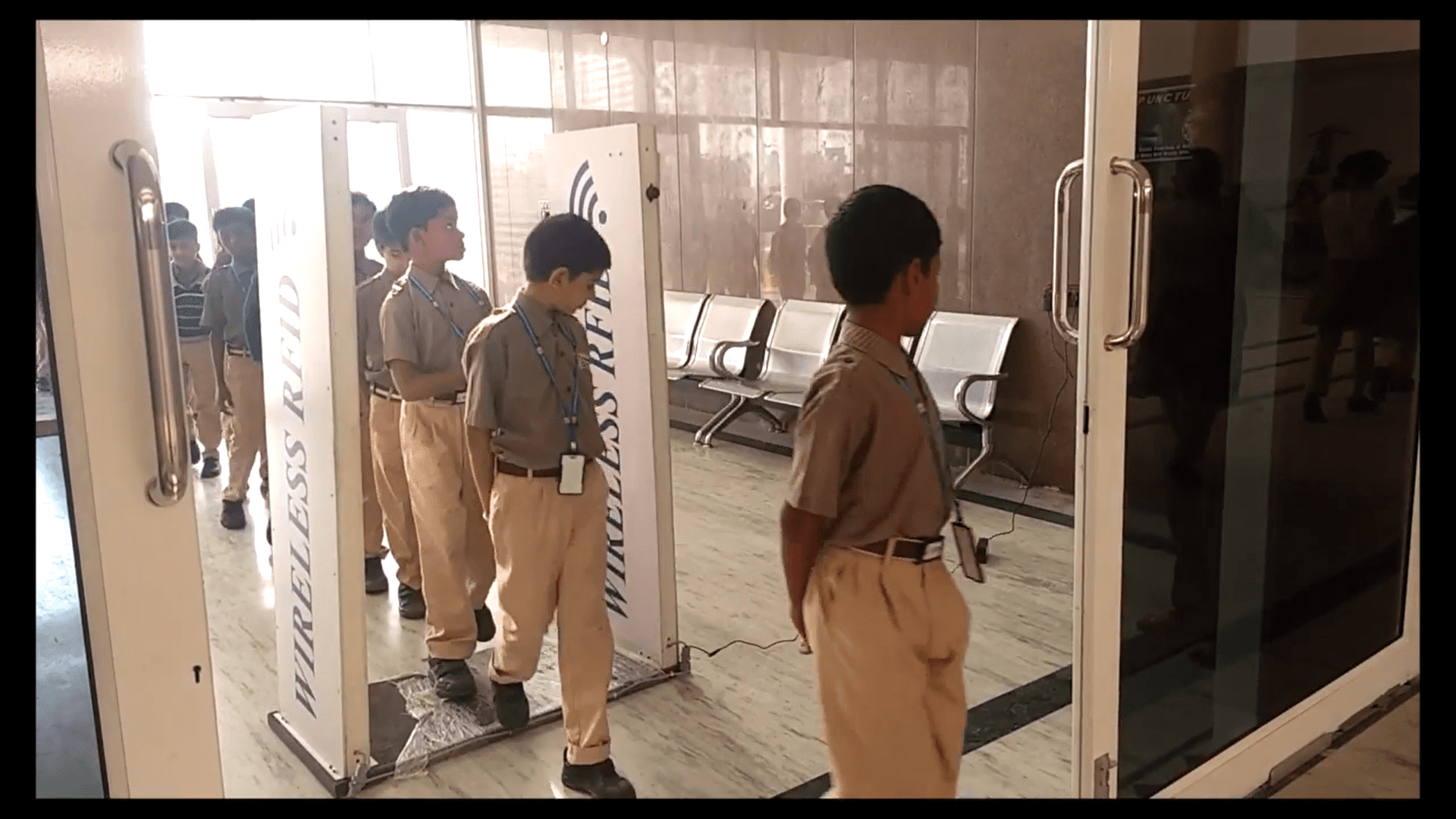 Students entering a Nepal school gate with RFID scanning.